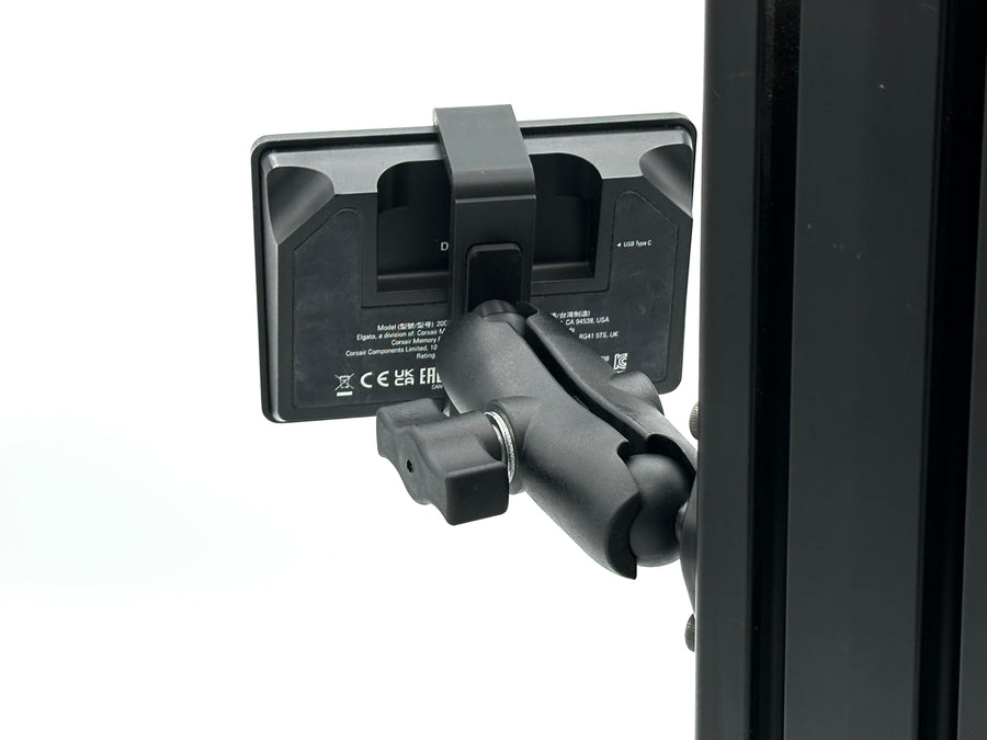 Image 5 — RAM Mount adjustability
Side view of the Stream Deck mount on an 8020 aluminium extrusion cockpit, showing the fully adjustable aluminium RAM Mount arm angled toward the driving or piloting position. The RAM Mount gives complete control over tilt, rotation, and orientation of the 15-key Elgato Stream Deck, letting sim racers and flight simmers fine-tune the viewing angle in seconds without removing the Stream Deck from its 3D printed bucket adapter.