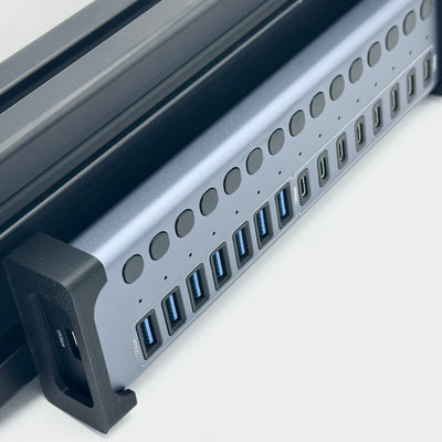 Acasis Sim Racing Mount viewed from the side on an aluminium extrusion cockpit, showing the USB hub's position against the profile. Compatible with the Acasis HB16Pro and HB16Max, the mount supports a compact cable management layout around the rig. A fixed hub position helps keep wiring organised when connecting USB pedals, a handbrake, a shifter or other compatible racing accessories.