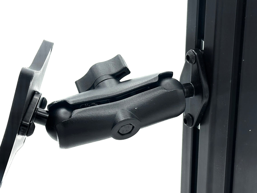 Button Box Mount installed on 40-series aluminium extrusion profile, positioning a compatible VESA button box beside the sim racing wheel. The RAM arm allows the control panel to be angled and positioned for comfortable access to pit commands, brake bias, traction control and camera shortcuts. T-nuts and profile bolts are included, creating a complete mounting setup for compatible 50, 75 and 100 mm VESA devices.