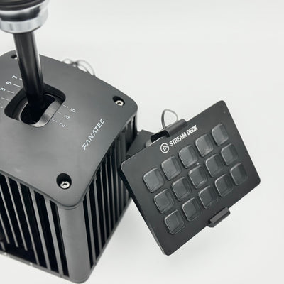 Fanatec ClubSport Shifter Stream Deck Mount adjusted toward the driving position to demonstrate its flexible sim racing setup. The base slides vertically along the shifter, the mid arm changes the left-to-right orientation, and the Stream Deck interface angles up or down, allowing the 15-key control panel to be aligned for comfortable viewing and reach during long racing sessions.