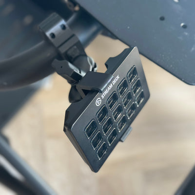 Playseat Trophy Stream Deck Plus Mount installed on the tubular cockpit frame, using the adjustable RAM arm to position the Stream Deck Plus beside the driver. The dedicated Plus interface supports a clean sim racing control layout for rotary-dial functions, car settings, pit controls and telemetry shortcuts. Choose the 5.5 cm RAM arm for a compact fit or 9.5 cm for more reach.